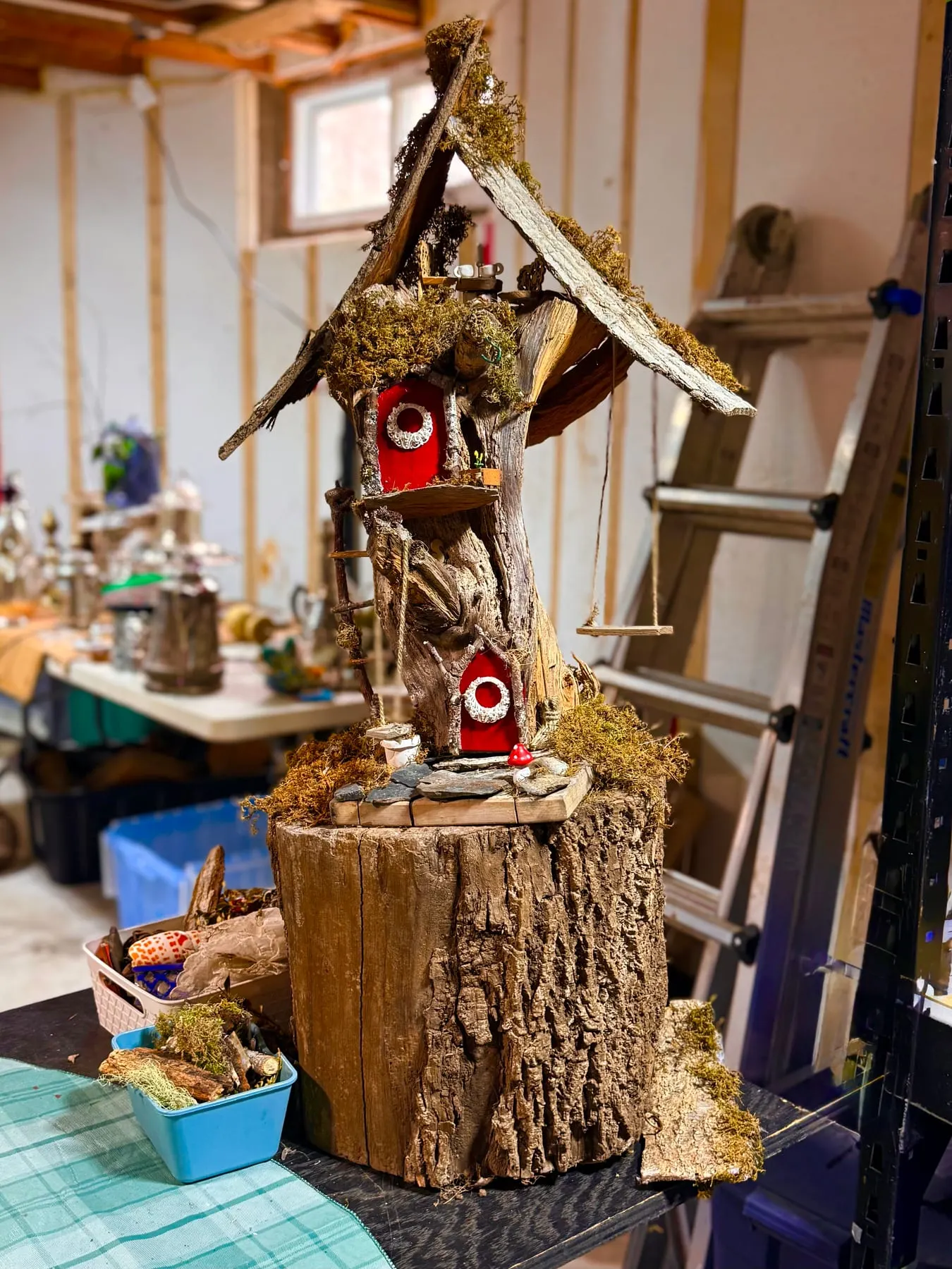 Volunteers’ handiwork at the Faerie HQ Workshop — a faerie house being carefully built on a stump.