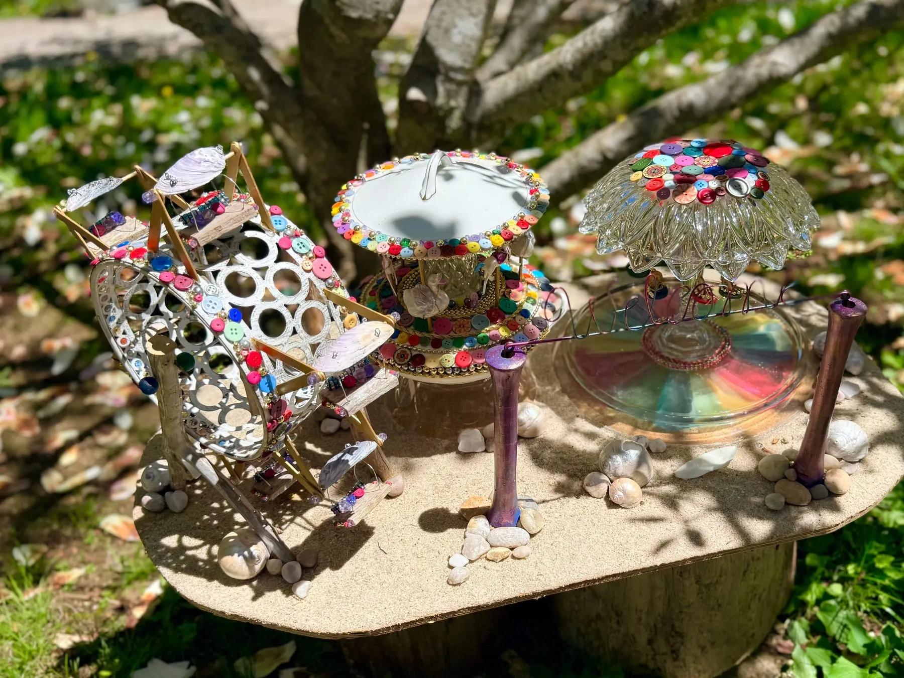 A spinning faerie merry-go-round made from a decorated glass dish.